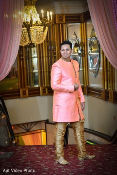 Indian groom posing on his Silk Kurta Set in golden and peach. Indian groom posing on his Silk Kurta Set in golden and peach.