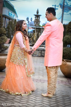 Golden and peach Indian bridal lehenga and grooms sherwani. Golden and peach Indian bridal lehenga and grooms sherwani.