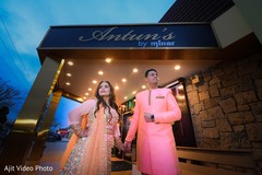 Indian lovebirds posing at engagement venue entrance. Indian lovebirds posing at engagement venue entrance.