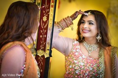 Indian bride admiring her tikka. Indian bride admiring her tikka.