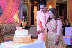 Indian engagement cutting peach and white cake moment. Indian engagement cutting peach and white cake moment.