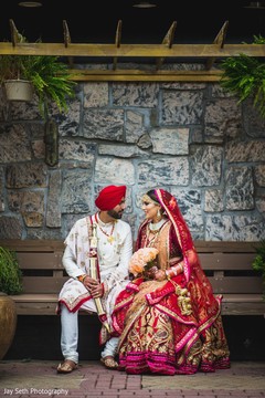Maharani holding a rose bouquet with Indian groom holding sword. Maharani holding a rose bouquet with Indian groom holding sword.