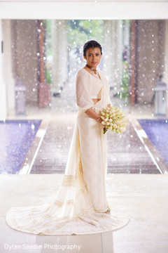 Portrait of the Indian bride wearing the white bridal saree. Portrait of the Indian bride wearing the white bridal saree.