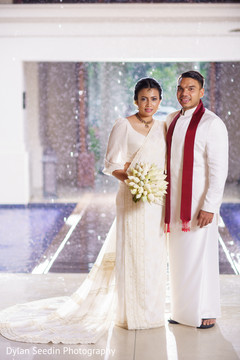 Indian bride wearing the white bridal saree design with Raja. Indian bride wearing the white bridal saree design with Raja.