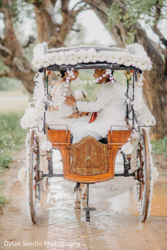 Maharani and Indian groom riding the decorated carriage. Maharani and Indian groom riding the decorated carriage.