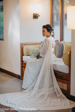 Indian bride wearing the white bridal saree during pictures. Indian bride wearing the white bridal saree during pictures.