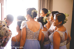 Bridesmaids taking a peek outside prior to the wedding. Bridesmaids taking a peek outside prior to the wedding.