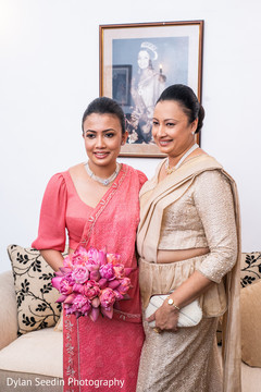 Indian bride wearing the pink bridal saree with the bouquet. Indian bride wearing the pink bridal saree with the bouquet.