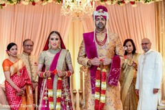 Maharani and groom holding their necklaces Maharani and groom holding their necklaces