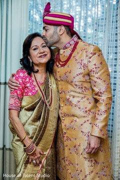 Indian groom kissing his mother. Indian groom kissing his mother.