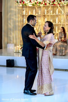 Indian groom wearing a suit and dancing with a relative. Indian groom wearing a suit and dancing with a relative.