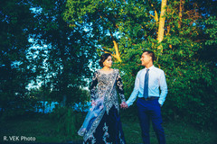 Raja and Indian bride holding hands during the photo session. Raja and Indian bride holding hands during the photo session.