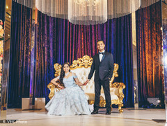 Maharani and Indian groom holding hands at the reception venue. Maharani and Indian groom holding hands at the reception venue.