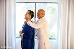 Indian groom being assisted by special guest prior to the ceremony. Indian groom being assisted by special guest prior to the ceremony.