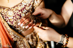 Indian bride showing her henna art and jewelry. Indian bride showing her henna art and jewelry.