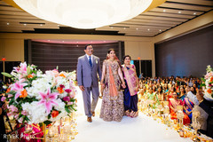 Indian bride making her entrance to the ceremony with parents. Indian bride making her entrance to the ceremony with parents.