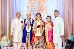 Indian newlyweds posing with family guests after the wedding. Indian newlyweds posing with family guests after the wedding.