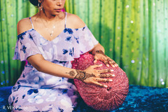 Indian bride showing her mehndi design during pictures. Indian bride showing her mehndi design during pictures.