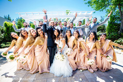 Bridesmaids with the newlyweds and the groomsmen in the back Bridesmaids with the newlyweds and the groomsmen in the back