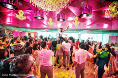 Friends and family lifting the newlyweds on their shoulders Friends and family lifting the newlyweds on their shoulders