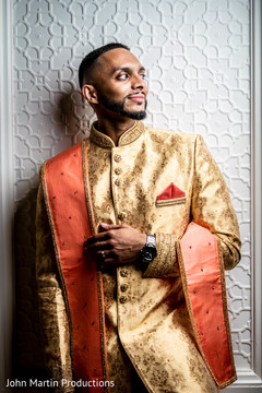 Indian groom in golden sherwani posing for picture. Indian groom in golden sherwani posing for picture.