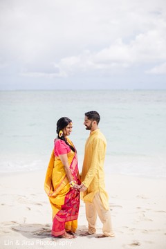 Maharani and groom gazing at each other in front of the ocean Maharani and groom gazing at each other in front of the ocean