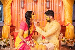 Groom applying more tumeric past to Maharani Groom applying more tumeric past to Maharani