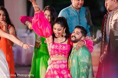 Indian couple and Indian relatives dancing during the Sangeet Indian couple and Indian relatives dancing during the Sangeet