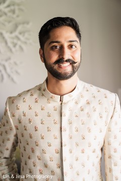 Indian groom with a white shewarni with golden details. Indian groom with a white shewarni with golden details.