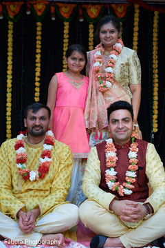 Indian groom with garland and Indian relatives during photo shoot. Indian groom with garland and Indian relatives during photo shoot.
