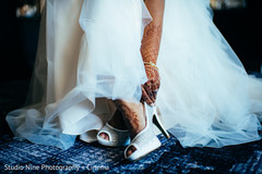 Closeup capture of maharanis white wedding shoes. Closeup capture of maharanis white wedding shoes.