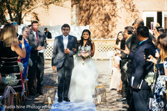 Indian bride walking down the aisle on her white wedding dress. Indian bride walking down the aisle on her white wedding dress.