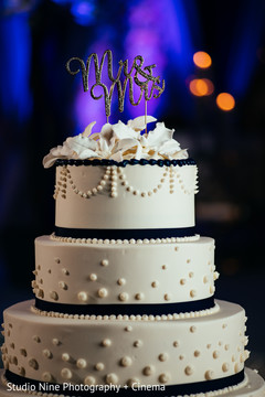 Golden Indian wedding white cake with golden cake topper. Golden Indian wedding white cake with golden cake topper.