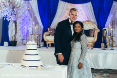 Indian newlyweds cutting the cake scene Indian newlyweds cutting the cake scene