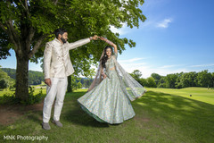 Indian couple outdoors on their light blue lehenga and white sherwani. Indian couple outdoors on their light blue lehenga and white sherwani.