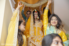Indian bride walking down the stairs on her yellow gown. Indian bride walking down the stairs on her yellow gown.