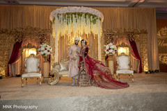 Indian couple posing at their wedding mandap. Indian couple posing at their wedding mandap.