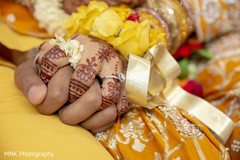 Closeup capture of Indian bride and groom holding hands. Closeup capture of Indian bride and groom holding hands.