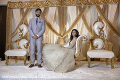 Indian couple posing at their reception stage. Indian couple posing at their reception stage.
