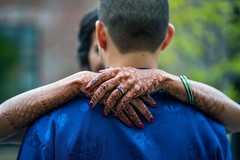 Indian bride hugging groom with her mehndi art on hands. Indian bride hugging groom with her mehndi art on hands.