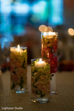 Sangeet table Candle holders full of flowers and water. Sangeet table Candle holders full of flowers and water.