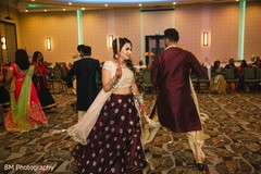 Indian groom and his maharani dancing with relatives Indian groom and his maharani dancing with relatives