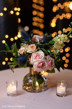 Indian wedding table pink, peach and zabelii Blue flowers centerpiece. Indian wedding table pink, peach and zabelii Blue flowers centerpiece.