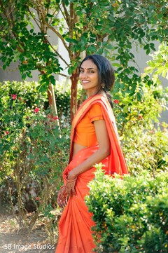 Maharani in an orange anarkali on the venue's yard Maharani in an orange anarkali on the venue's yard