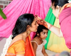 Tumeric paste being applied to Maharani by an Indian relative Tumeric paste being applied to Maharani by an Indian relative