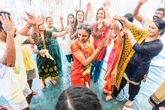 Maharani being washed while Indian relatives dance around Maharani being washed while Indian relatives dance around