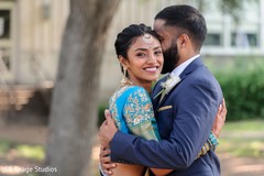 Maharani smiling while hugging her Indian groom. Maharani smiling while hugging her Indian groom.