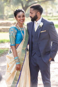 Indian groom in grey suit looking at his Maharani. Indian groom in grey suit looking at his Maharani.