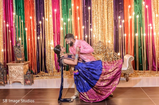 Maharani in blue anarkali posing with her Indian groom.