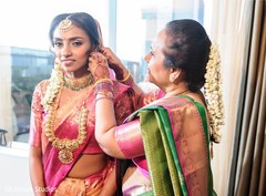 Maharani being assisted with her earrings. Maharani being assisted with her earrings.